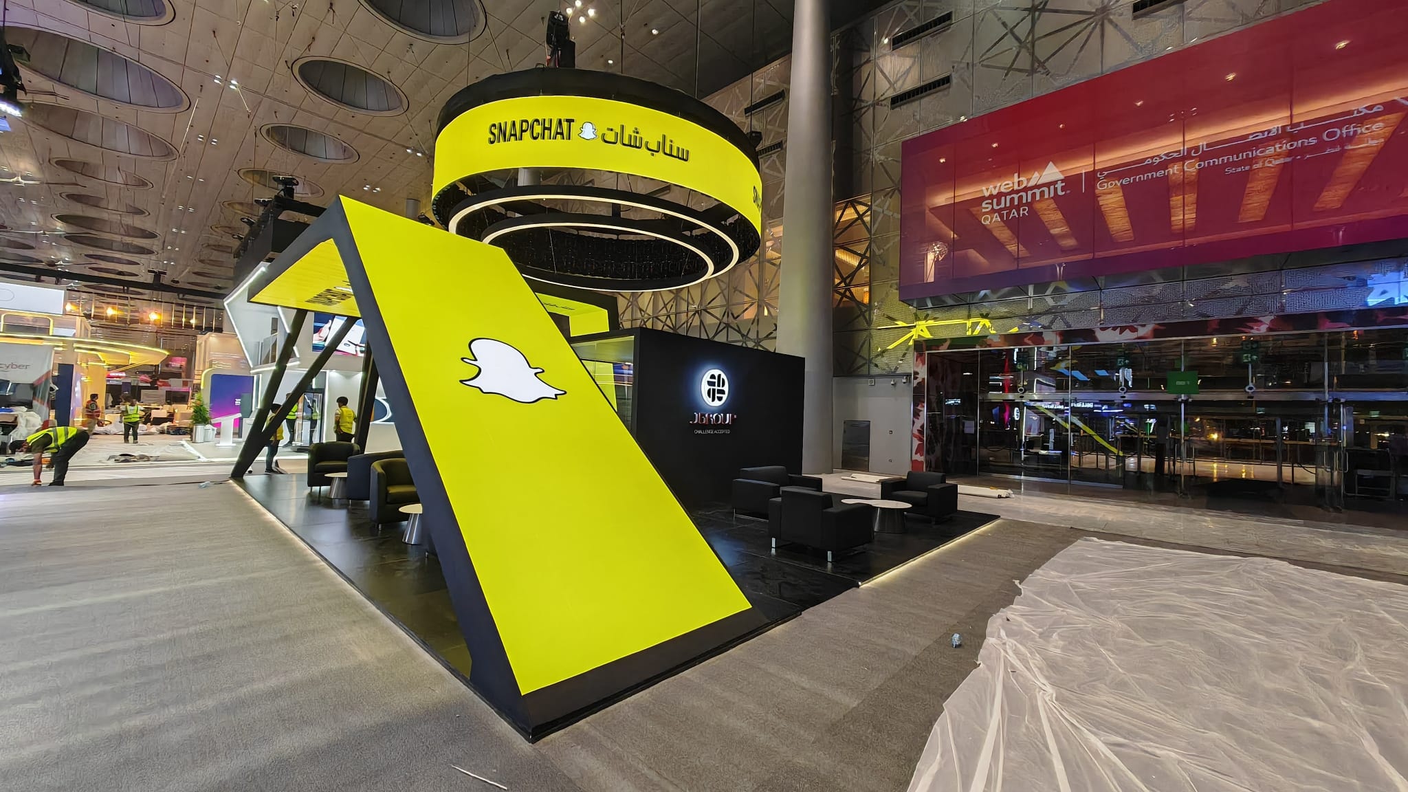 Custom-built J Group stand with a yellow Snapchat-branded blade at Web Summit 2026